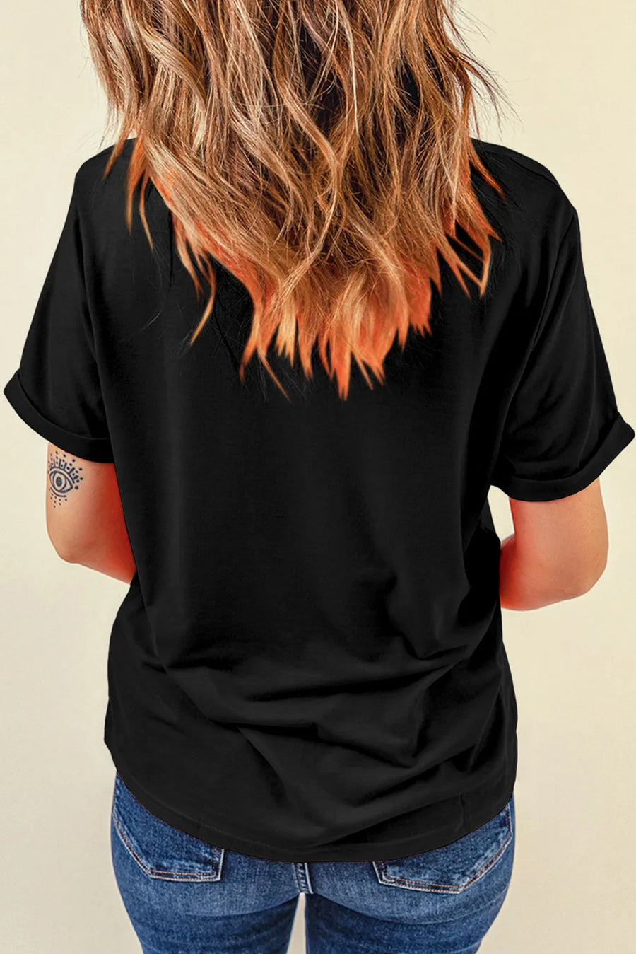 Black graphic t-shirt with rolled sleeves and a relaxed fit.