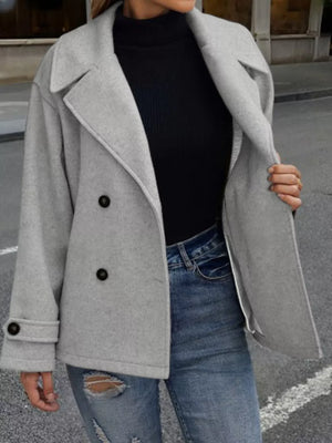 Light gray double-breasted wool blend pea coat with black buttons, cuffed sleeves, and lapel detail.