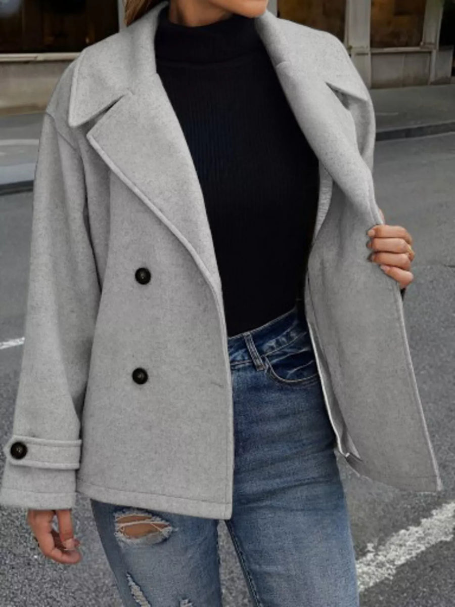 Light gray double-breasted wool blend pea coat with black buttons, cuffed sleeves, and lapel detail.