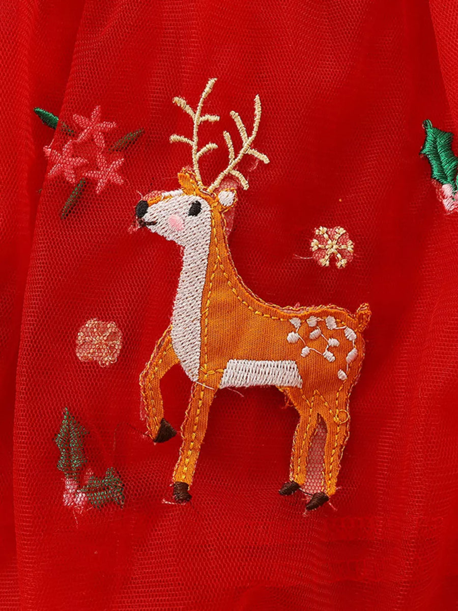 Red tulle dress with festive elk embroidery and floral accents.