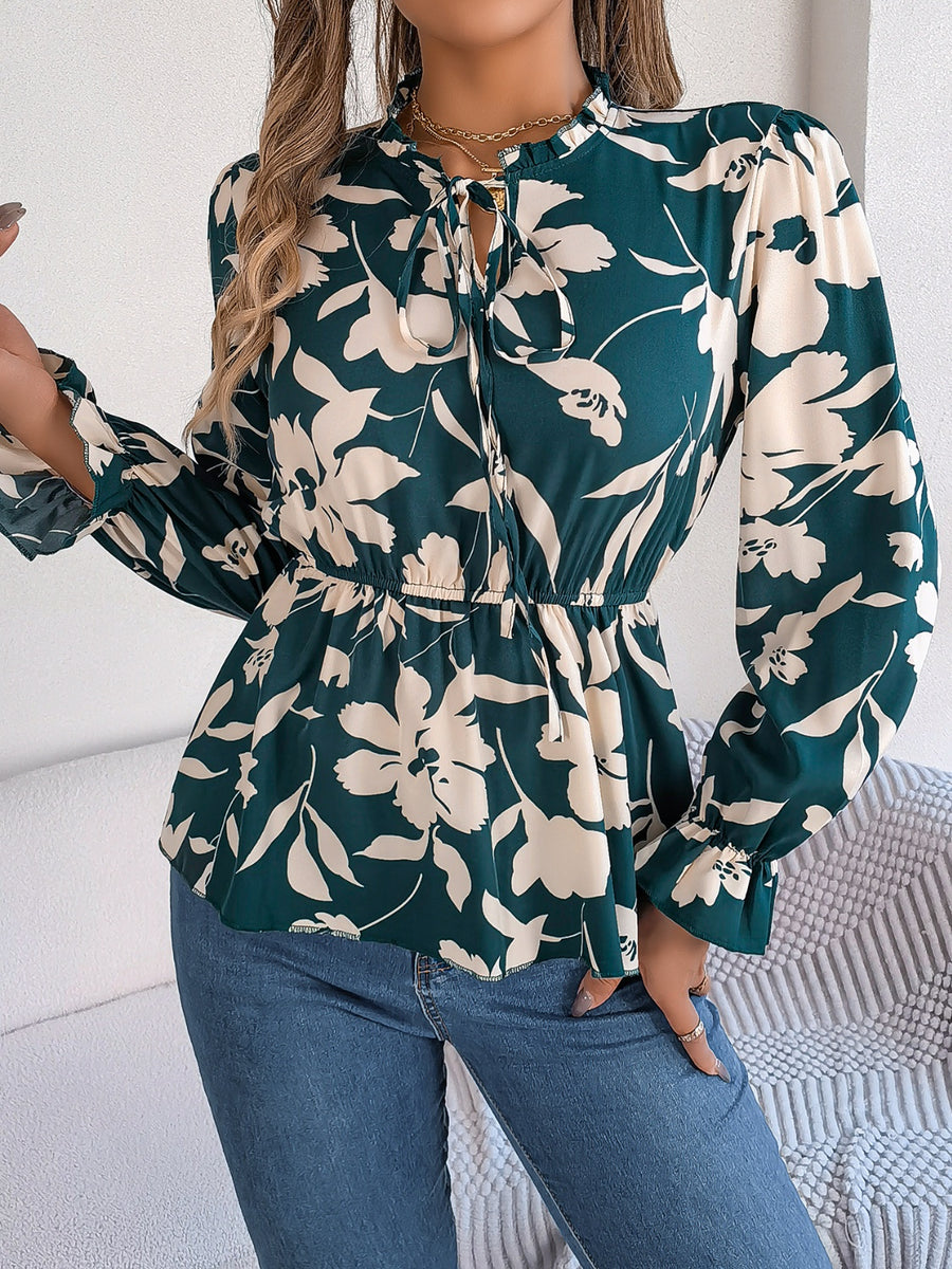 Deep Teal floral peplum blouse with ruffled neck and tie detail, long sleeves.