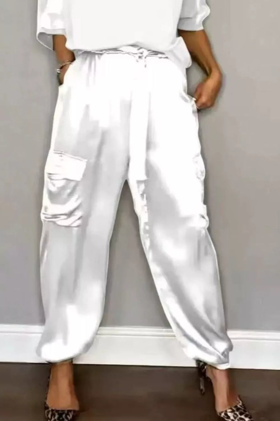 White satin cargo pants with drawstring waist and cuffed ankles