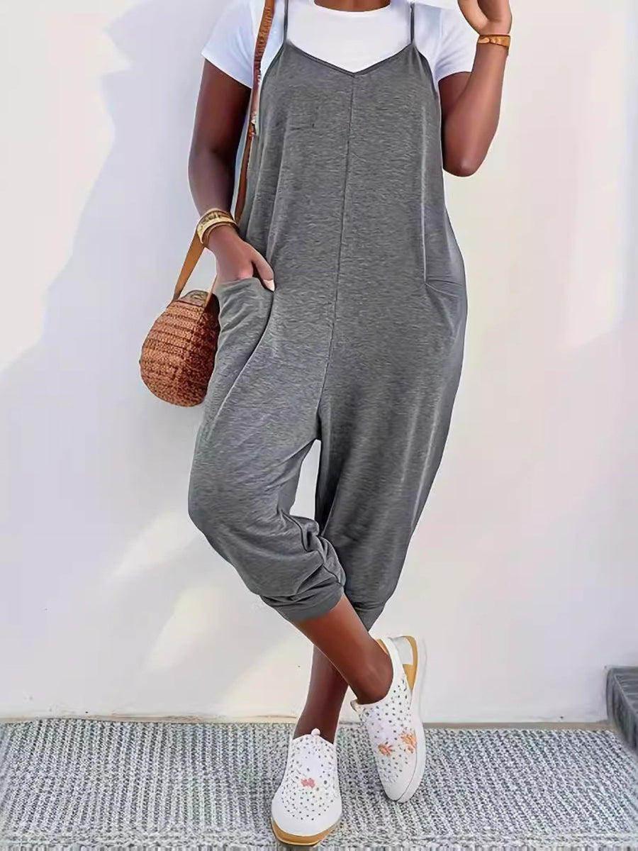Heathered dark gray loose fit spaghetti strap jumpsuit with pockets and cropped legs.