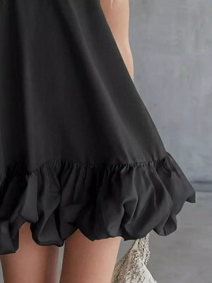 Black V-neck mini dress with bubble hem detail.