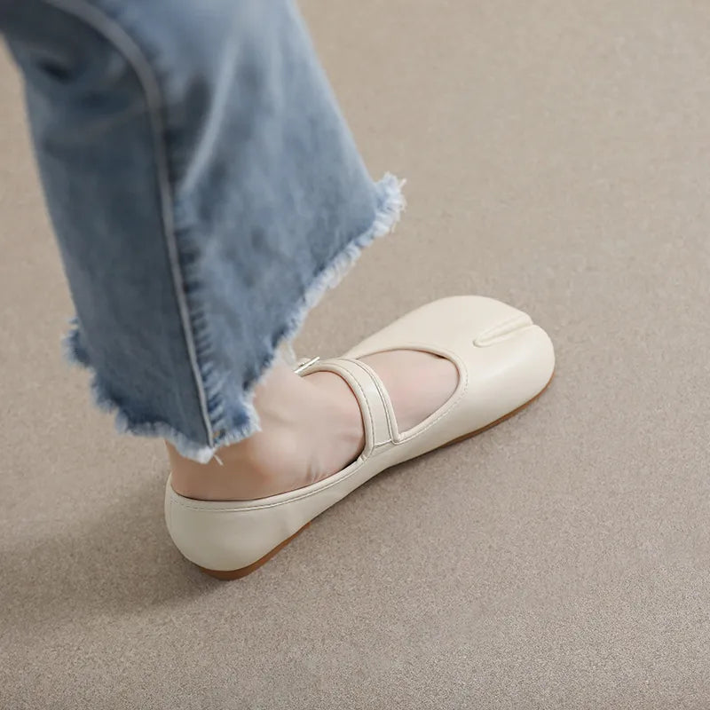 Beige tabi Mary Jane flats with a strap, styled with cropped frayed jeans.