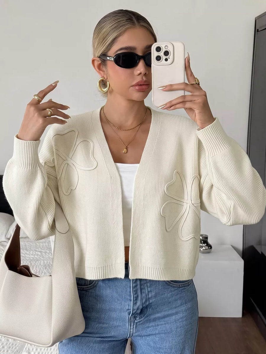 Beige cardigan featuring open-front and four-leaf clover motif