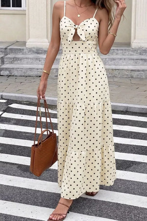 Cream polka dot maxi dress with tie-front cutout and tiered skirt.