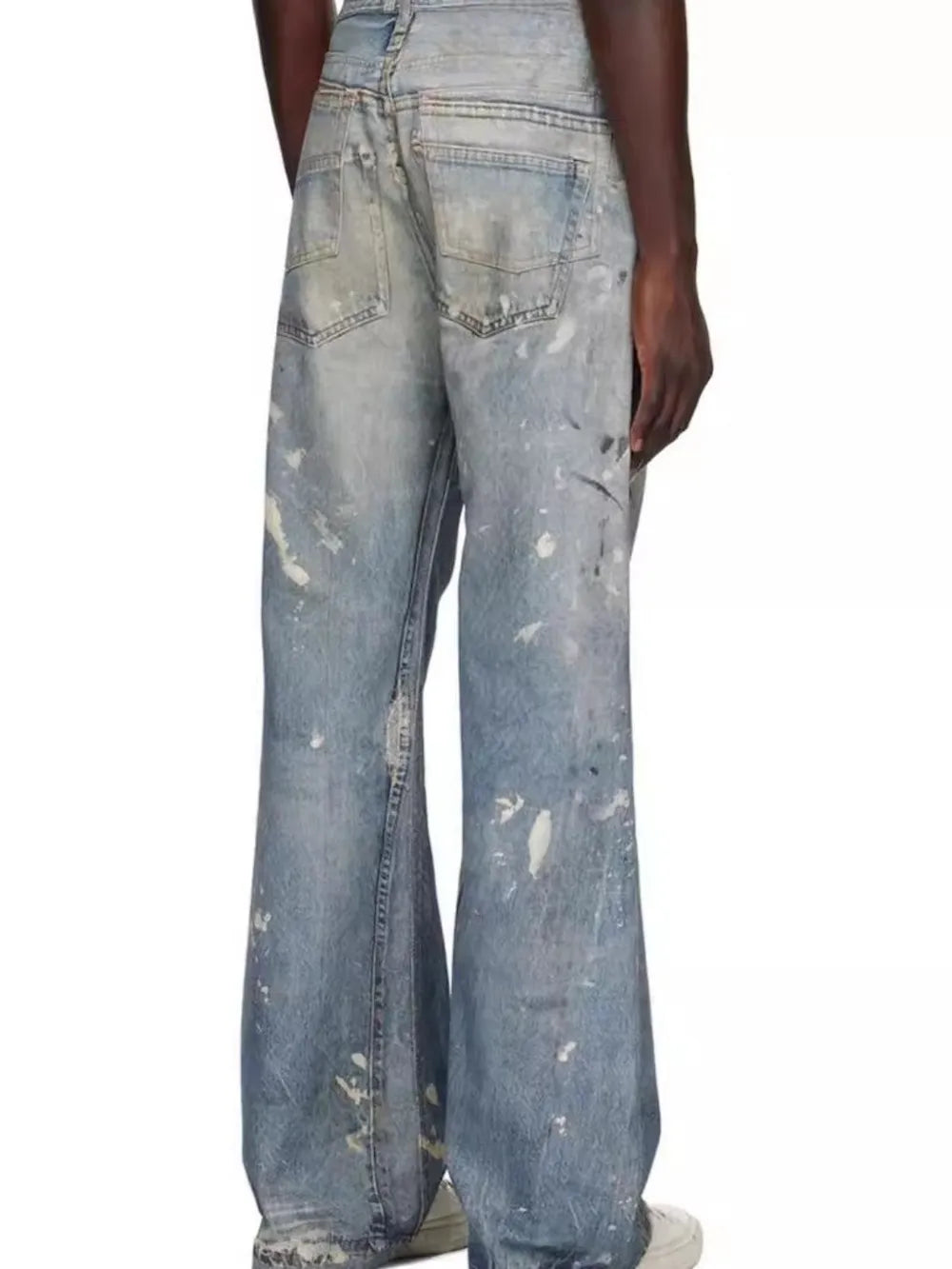 Distressed wide-leg denim jeans in medium wash with paint splatters and a relaxed fit.