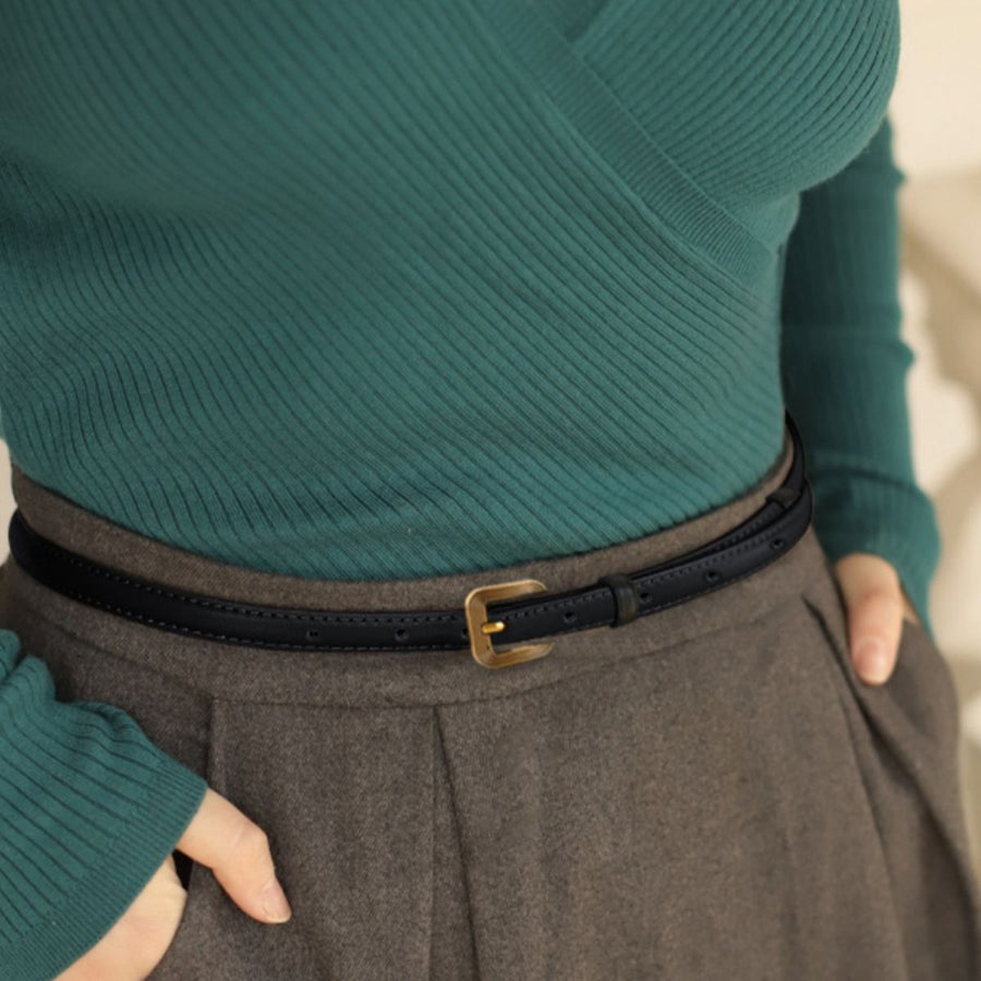 Black cowhide leather accent belt with antique brass buckle and punched holes detail.