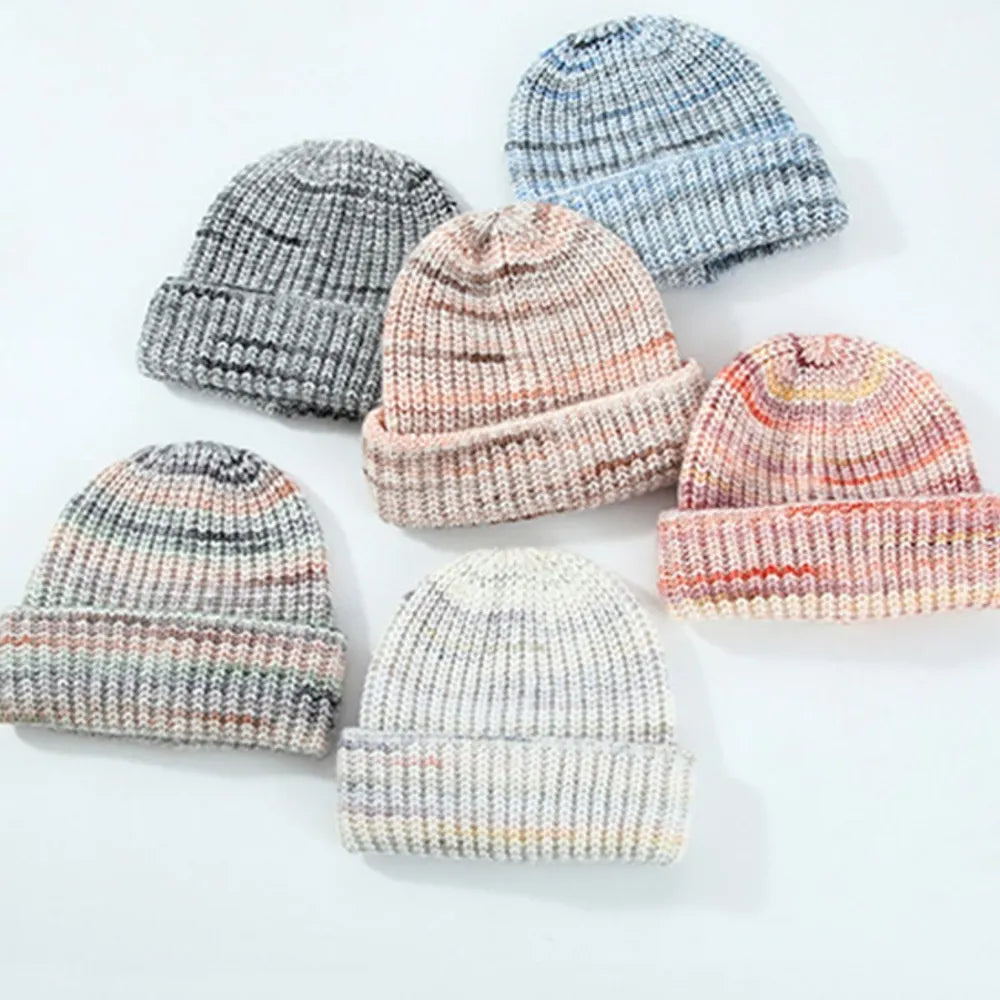 Textured mélange ribbed beanies in cream, gray, and pastel blue.