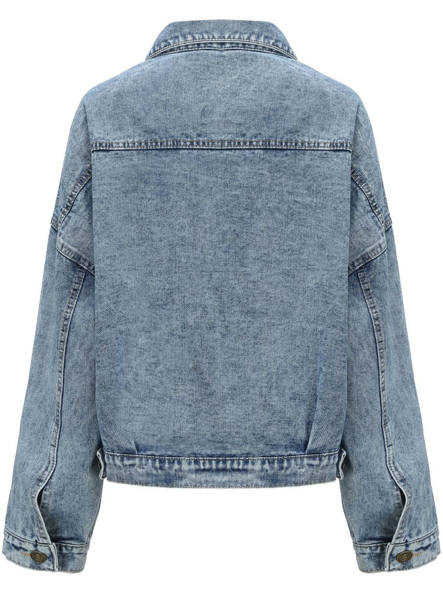 Light wash oversized denim jacket with buttoned cuffs and patch pocket detail.