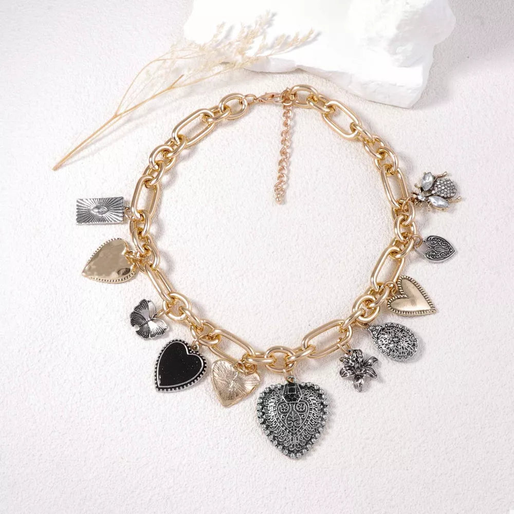 necklace in gold featuring charm details and chunky fit