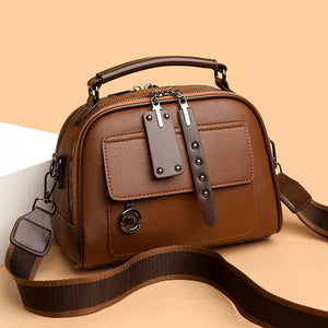 Brown leather crossbody bag with adjustable strap and front pocket detail
