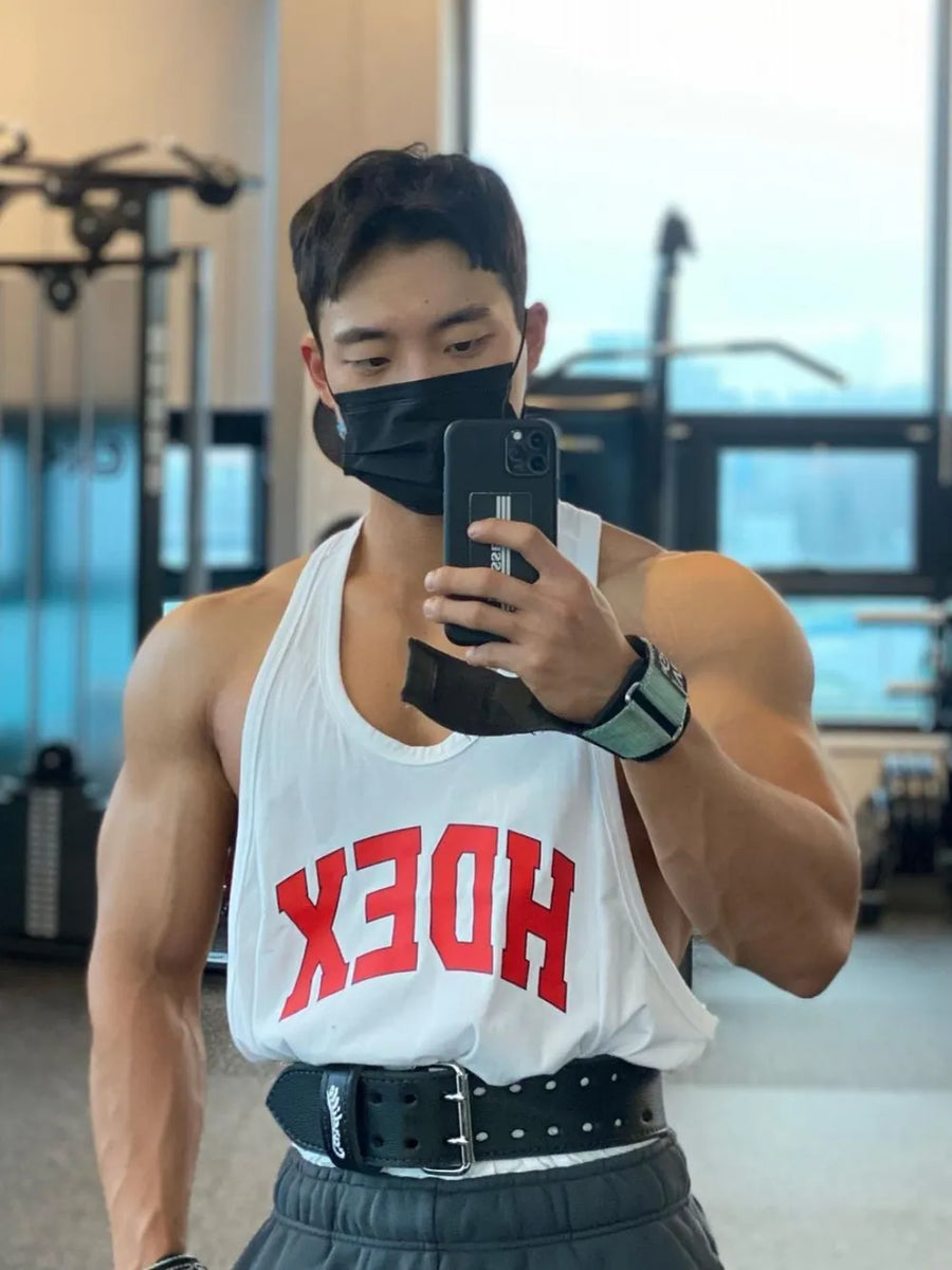 White athletic tank top with red graphic lettering, men's activewear