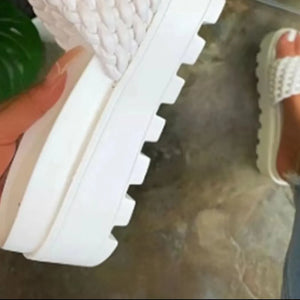 White woven platform slide sandals with a thick lug sole.