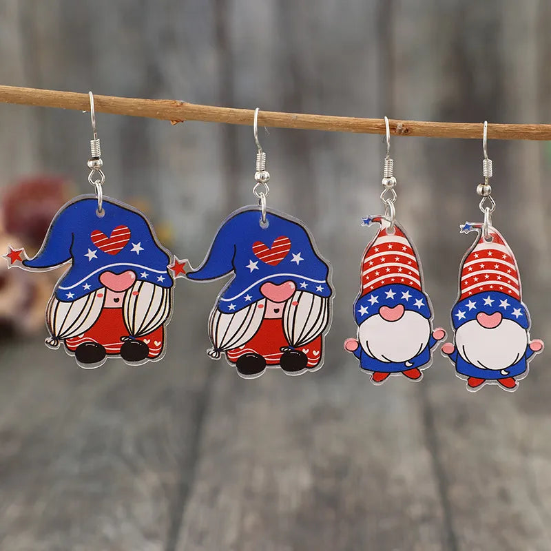 Patriotic gnome acrylic dangle earrings in royal blue with red and white star patterns.