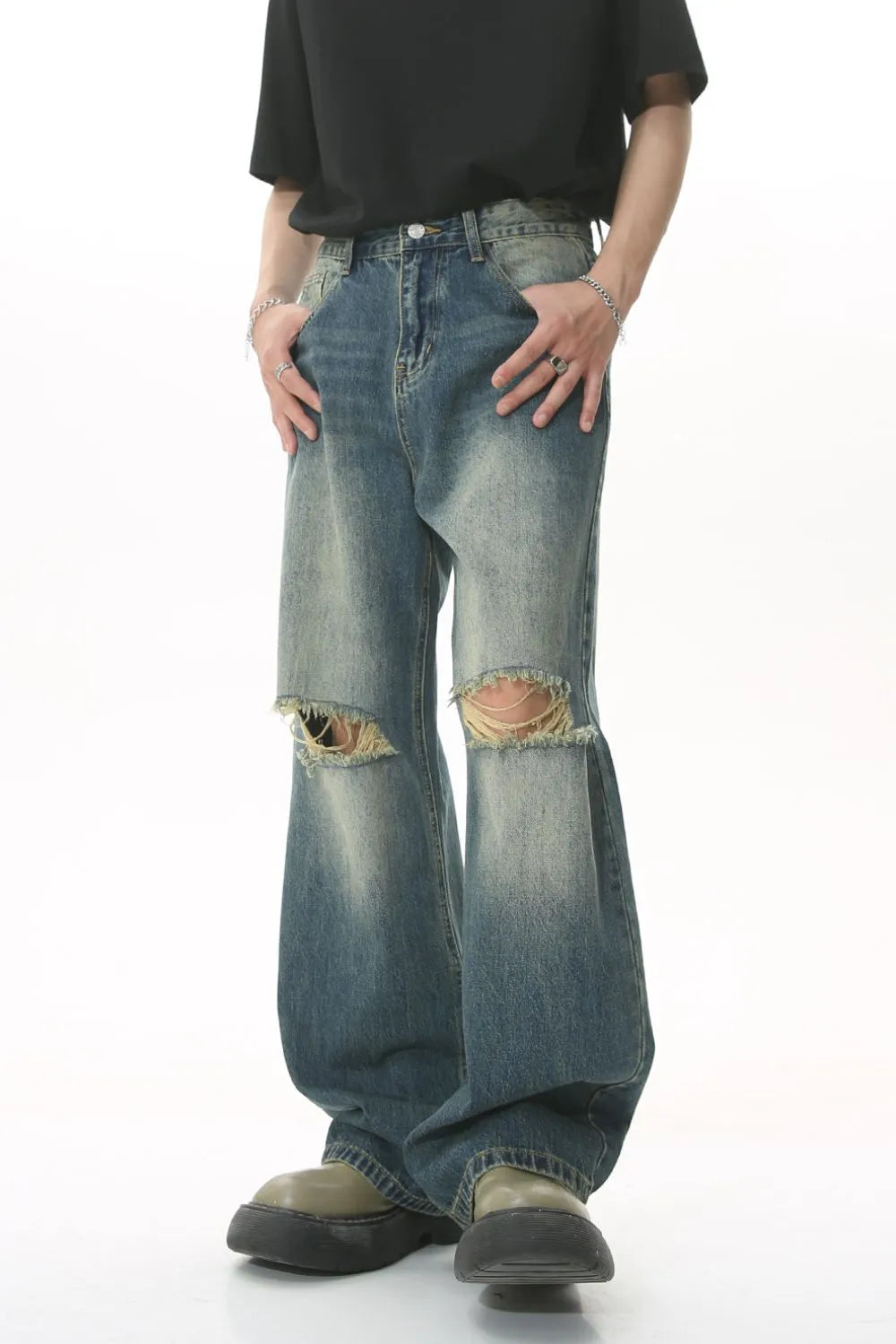 Distressed knee rip wide-leg jeans in medium wash denim with a relaxed fit.
