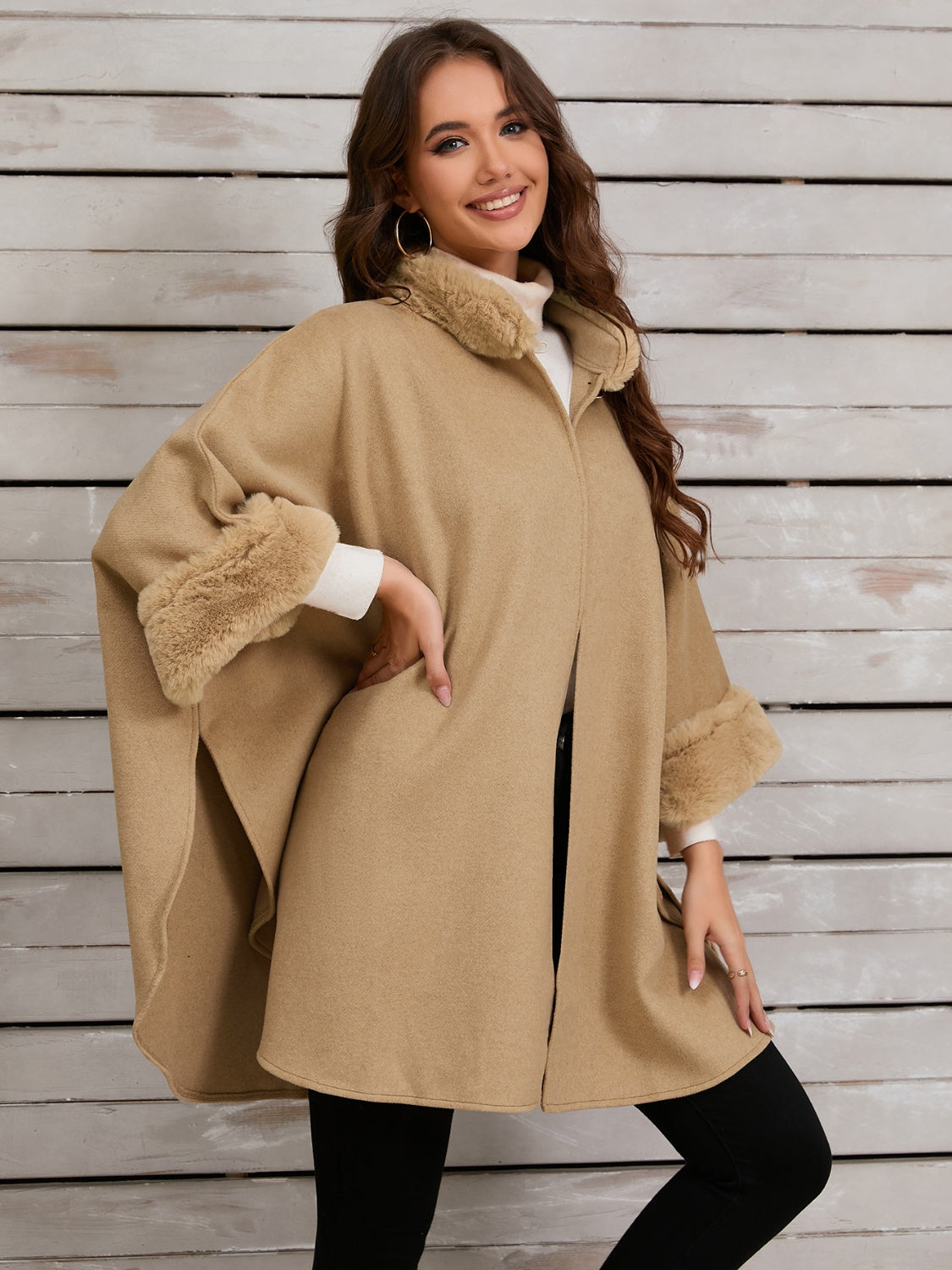 Tan cape coat with faux fur trim on collar and cuffs.