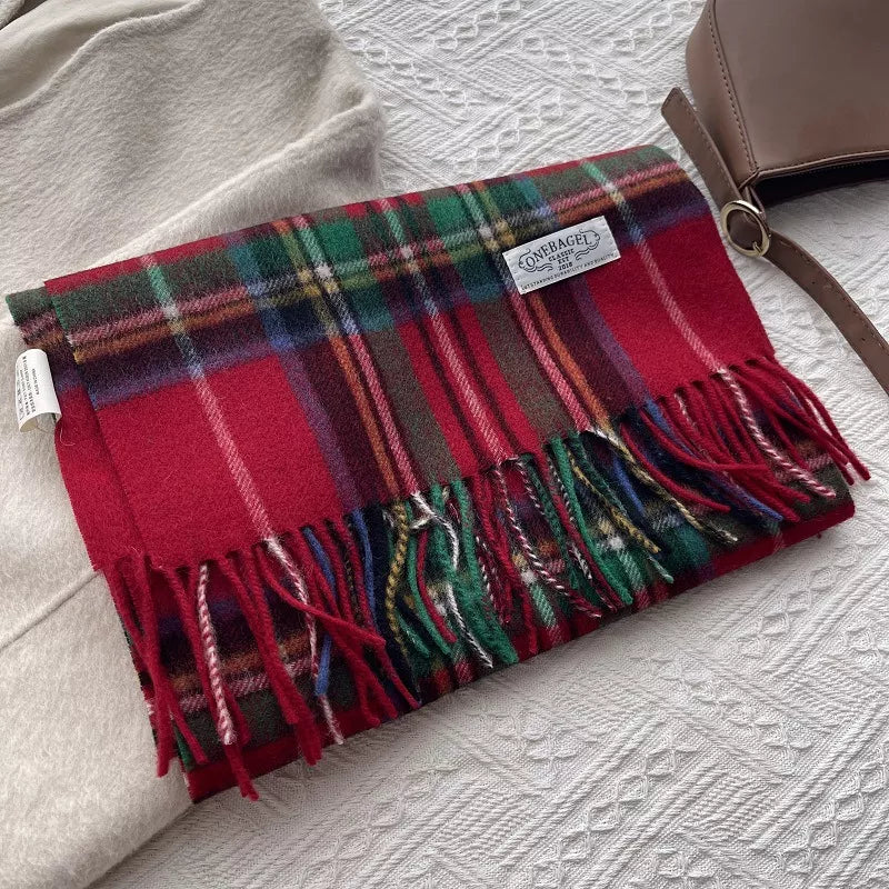 Classic wool plaid scarf with tassels in red, green, and blue tartan pattern.