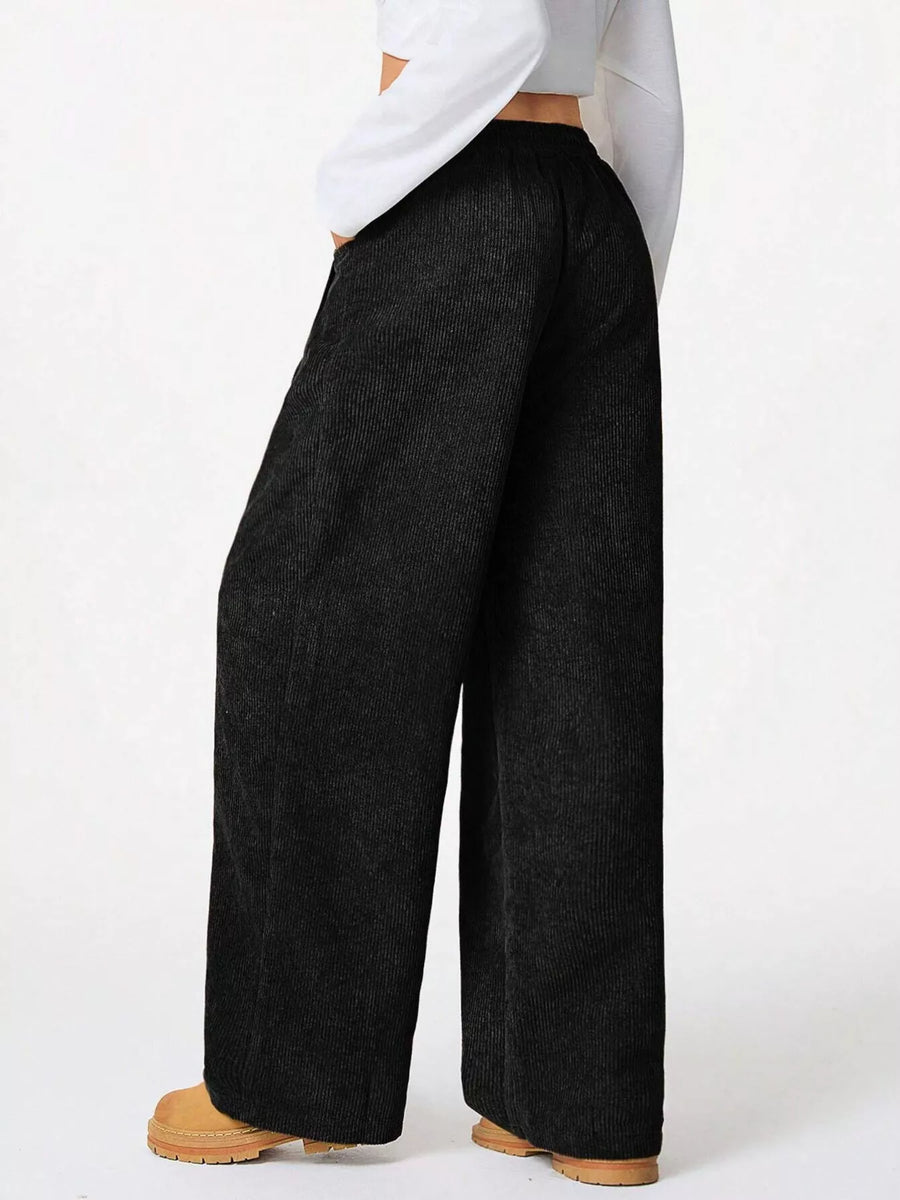 Black corduroy relaxed fit pants with drawstring waist and wide leg
