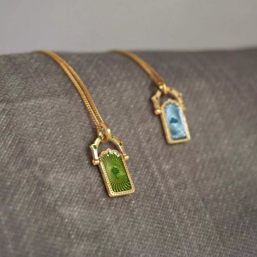 necklace in gold with graphic and pendant