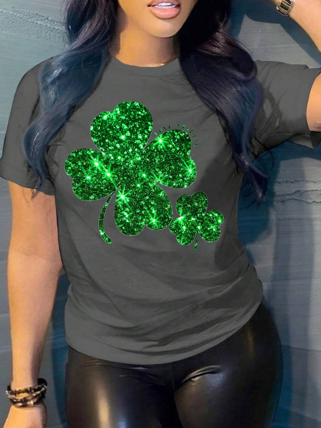 Dark gray t-shirt with a large glittery green shamrock graphic.