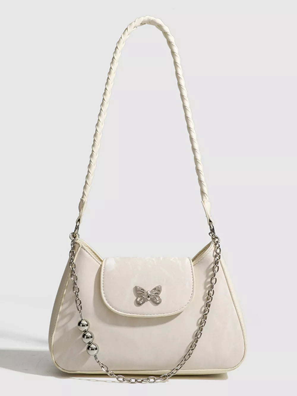 White shoulder bag with butterfly charm and beaded chain detail
