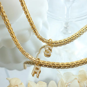 Gold chain necklace with diamond initial pendants R and S
