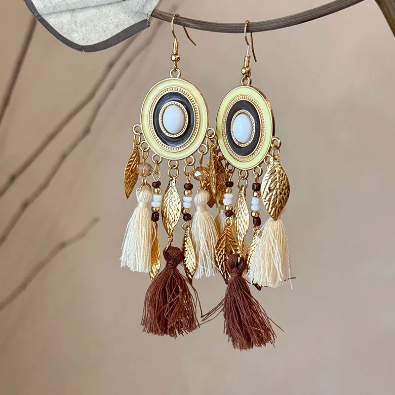 Feathered cascade & enamel drop earrings in blue and brown with tassels and leaf charms.