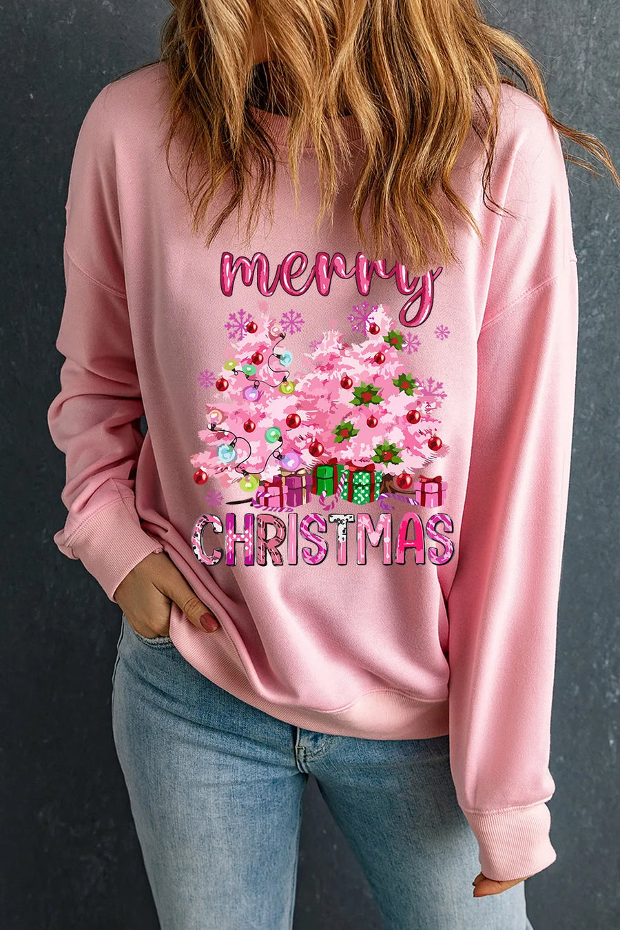 Pink Christmas graphic sweatshirt with trees and presents, featuring "Merry Christmas" text.