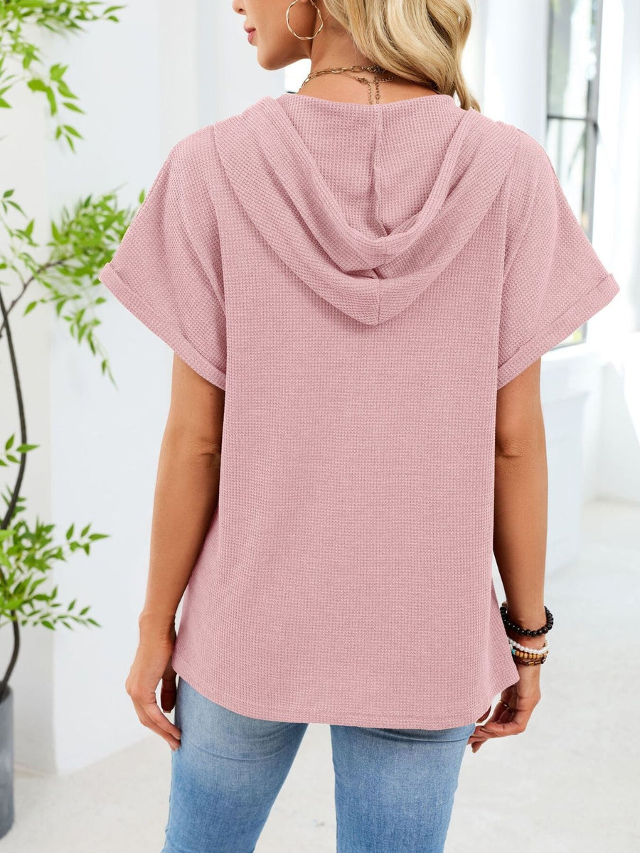 Pink waffle knit short sleeve hooded top with cuffed sleeves.