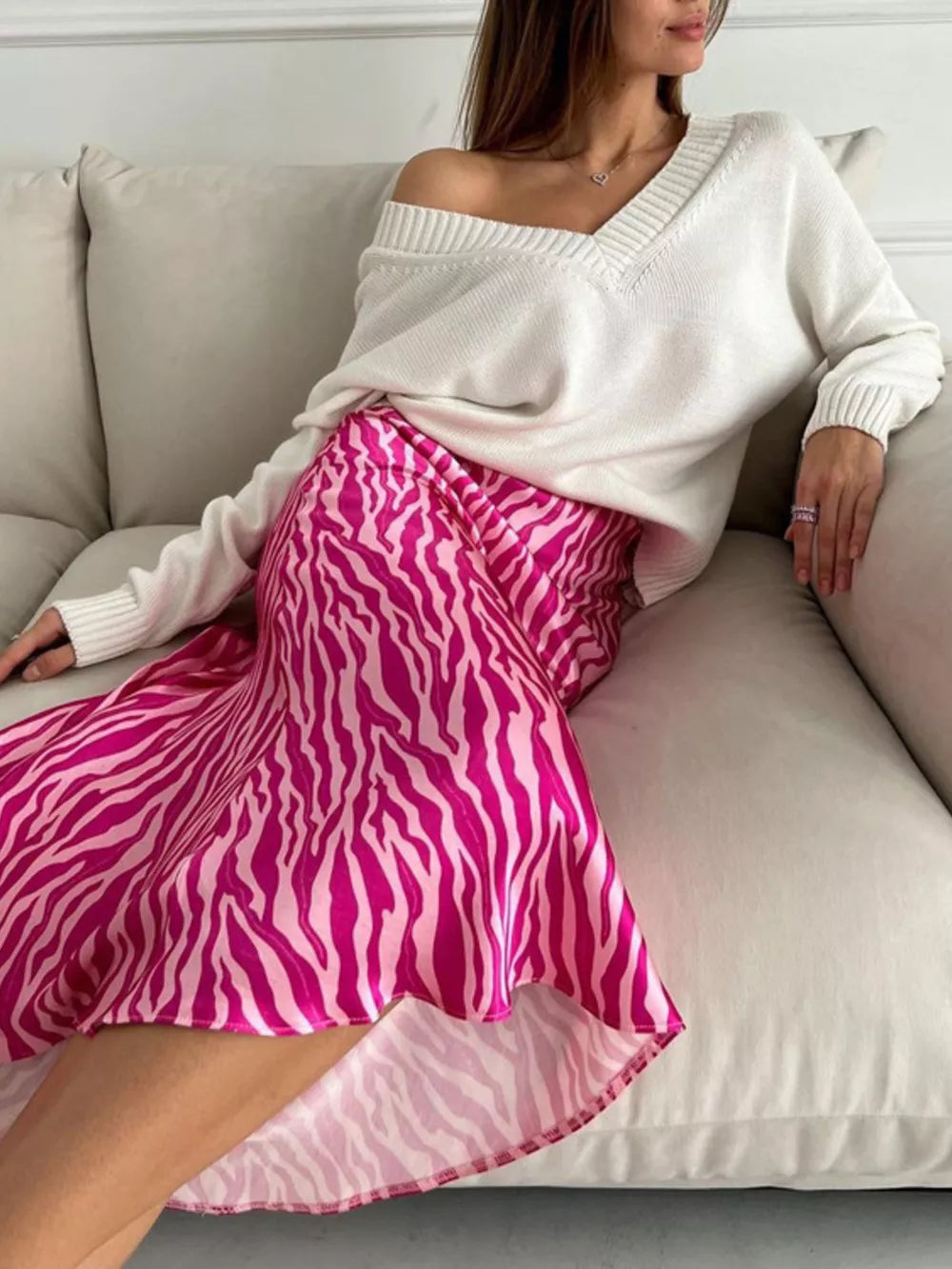 Satin midi skirt with a vibrant pink and white zebra print.