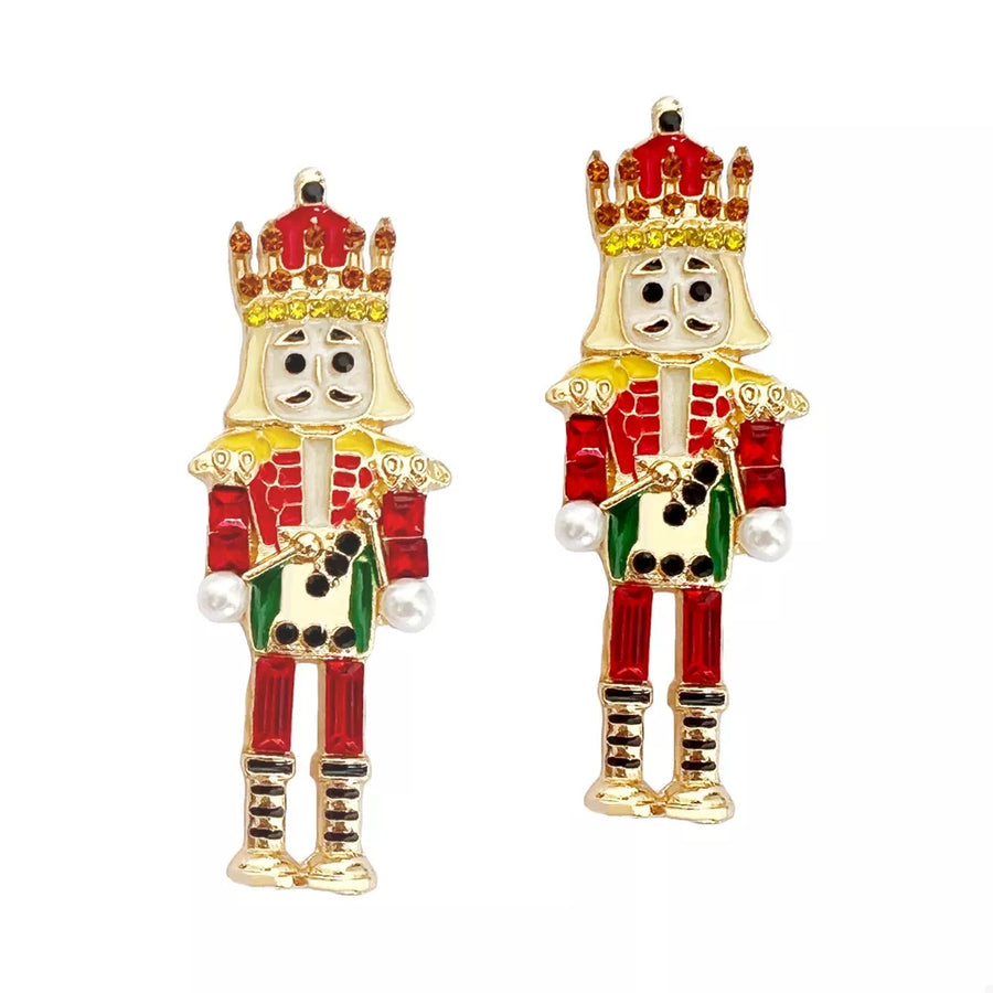 Whimsical nutcracker dangle earrings in red and gold with pearl accents.
