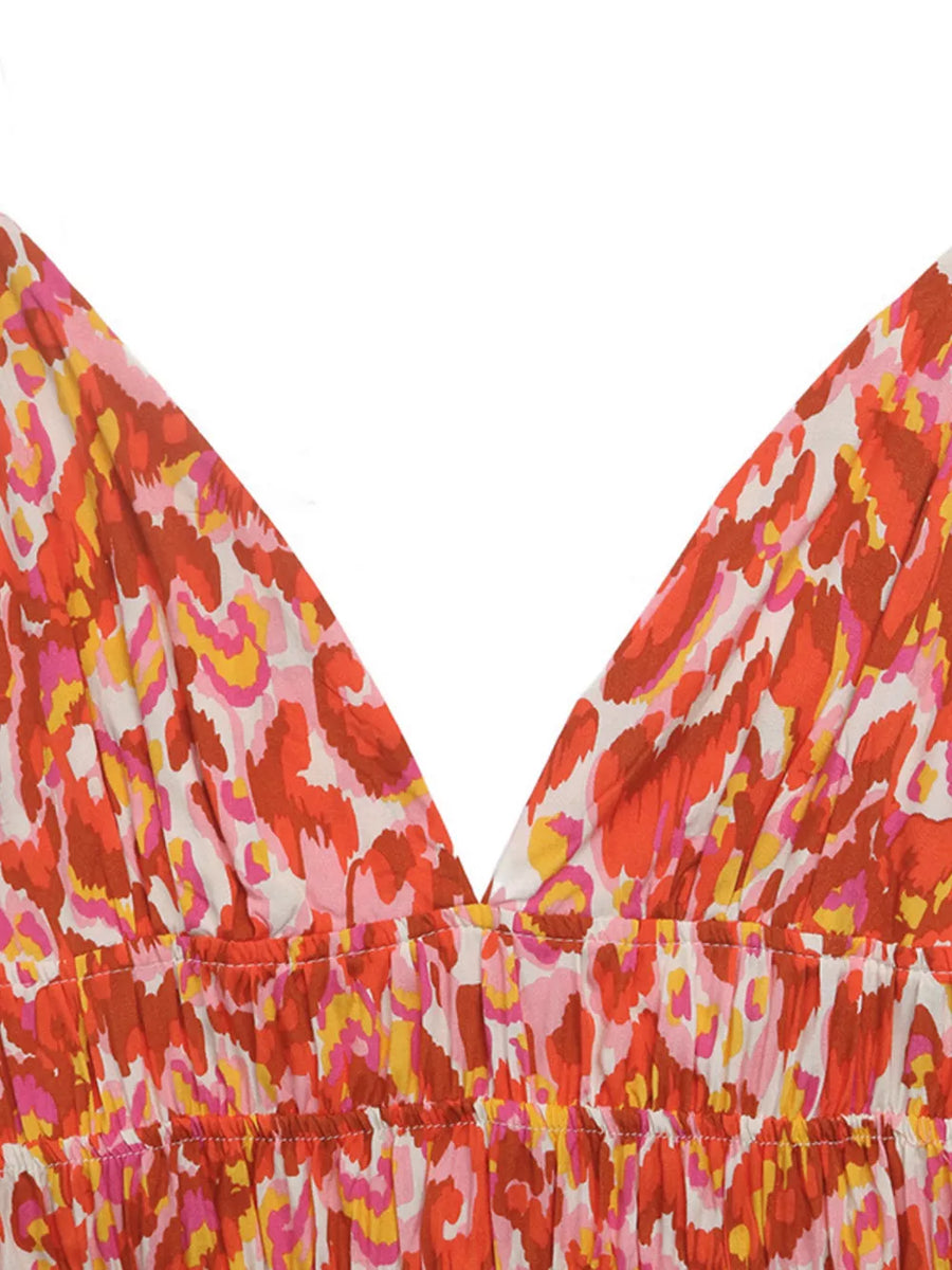 Abstract print V-neck maxi dress with ruched bodice in colorful abstract pattern.