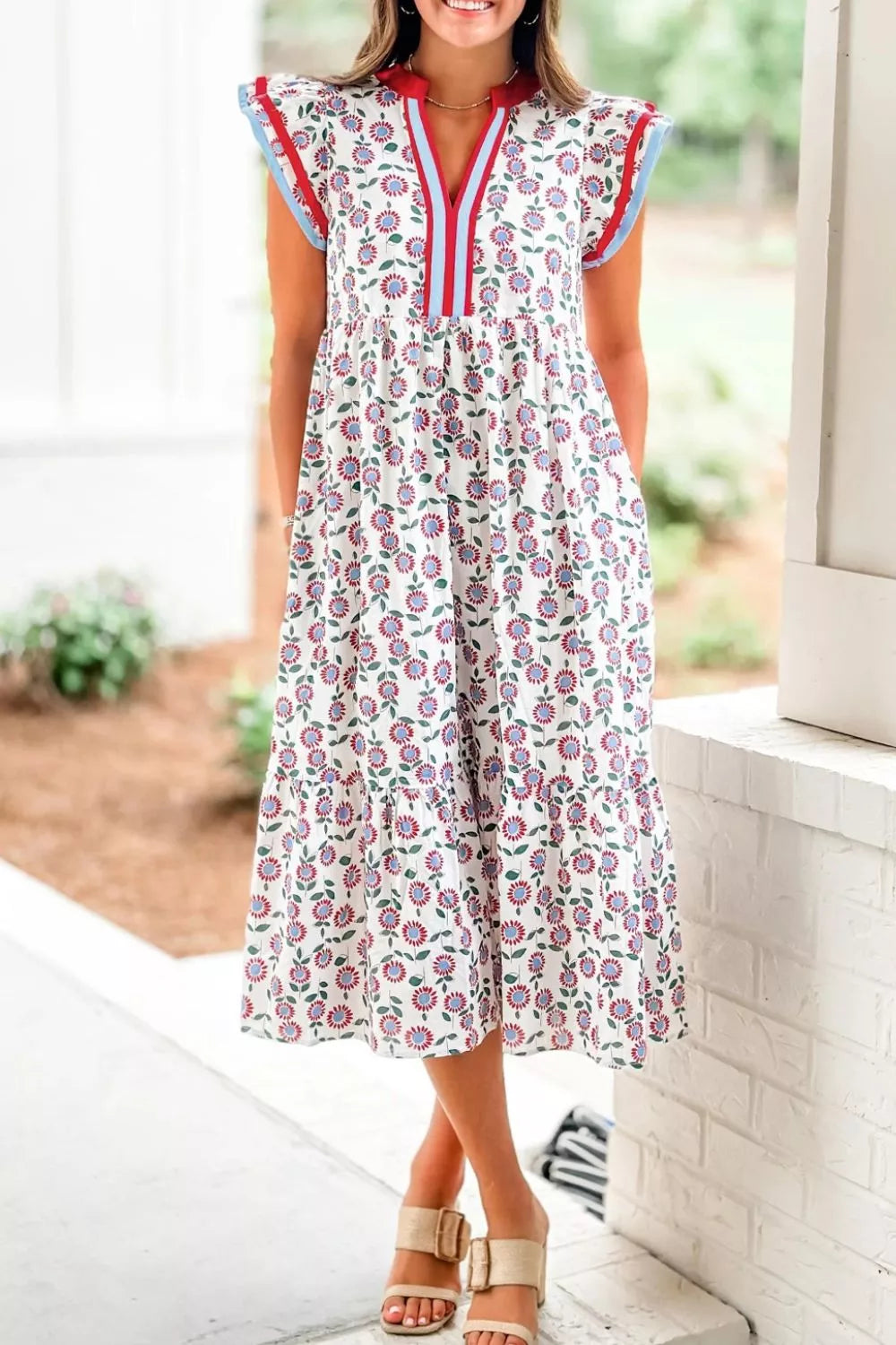 Vibrant floral tiered midi dress with V-neck and short sleeves, made of cotton.