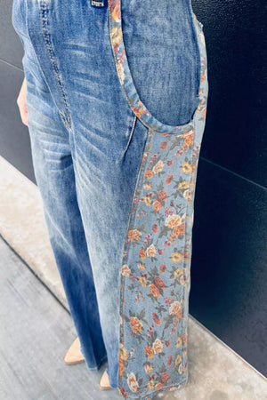 Denim overalls with vintage floral print side panels and straps.