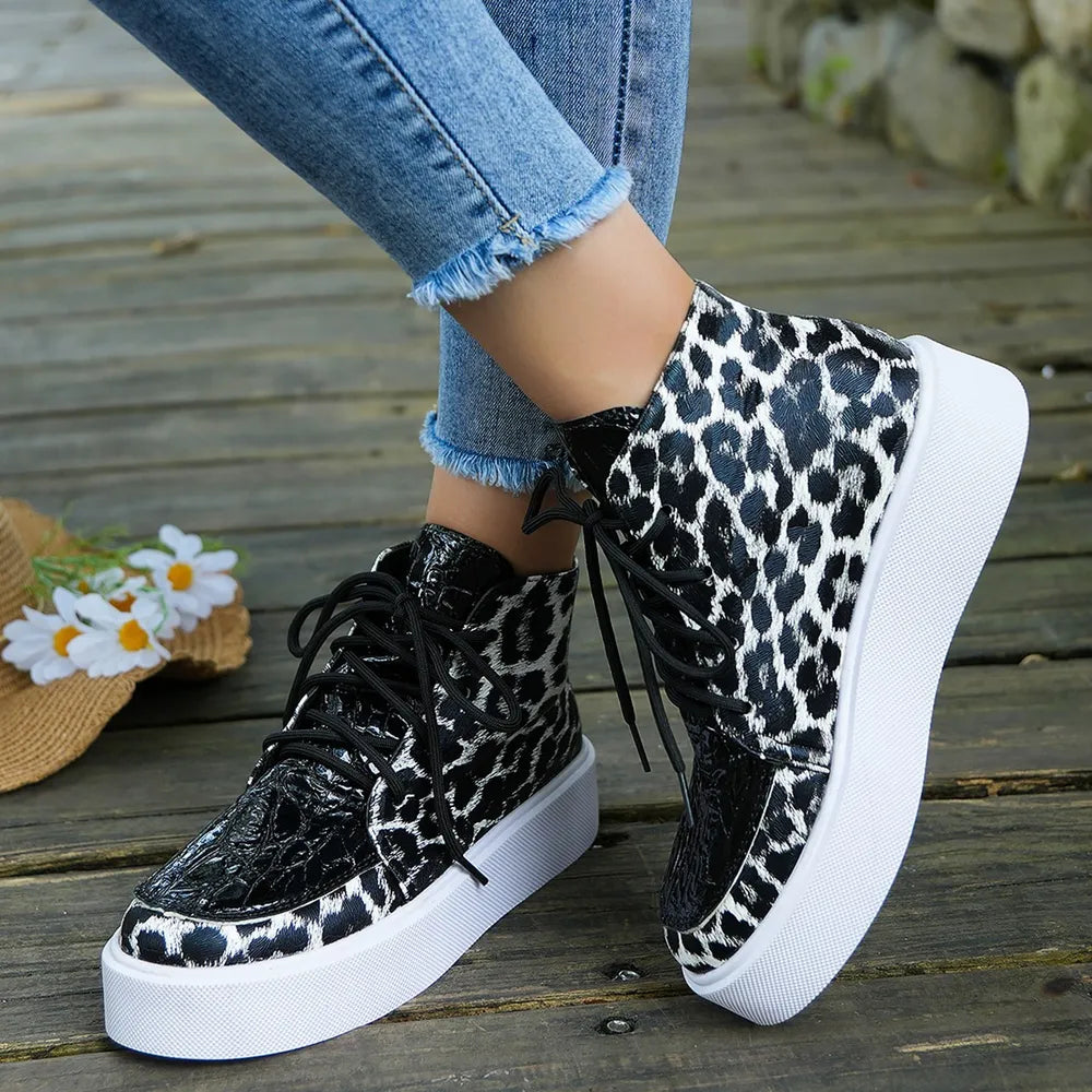 Patent leopard platform high-tops in black with white accents and a white sole.