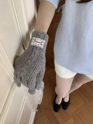Gray cable knit gloves with decorative patch detail