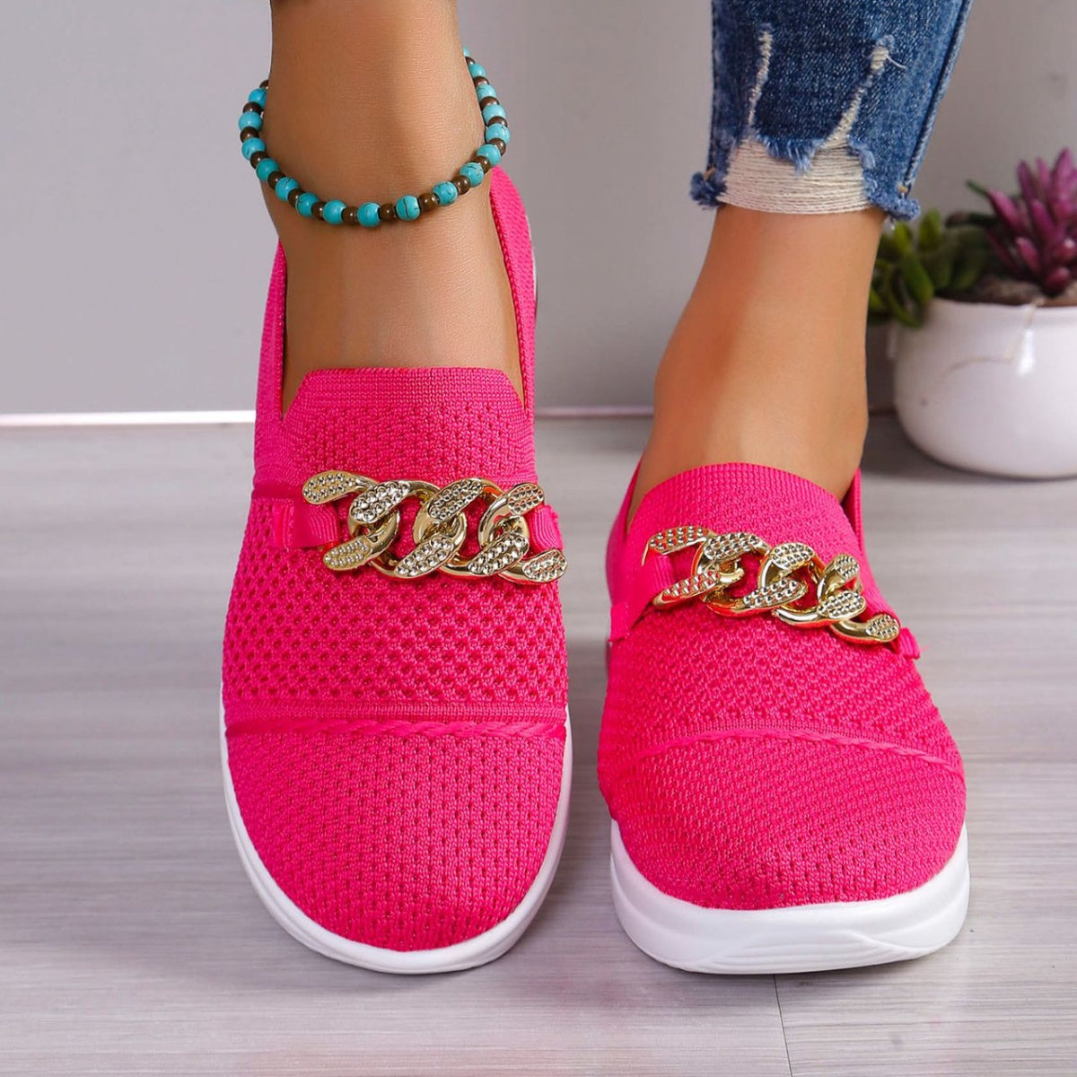 Rose red mesh slip-on flats with chunky chain detail and white soles.