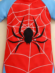 Toddler one-piece swimsuit in red with white spiderweb and black spider graphic, blue sleeves.