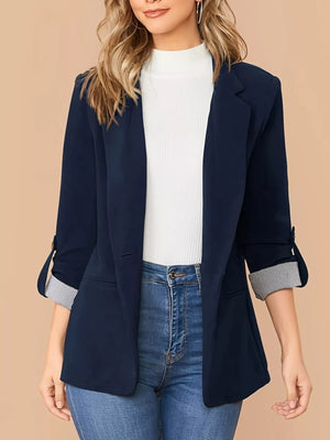 Navy blue blazer with roll-up sleeves featuring striped cuffs, single button closure.