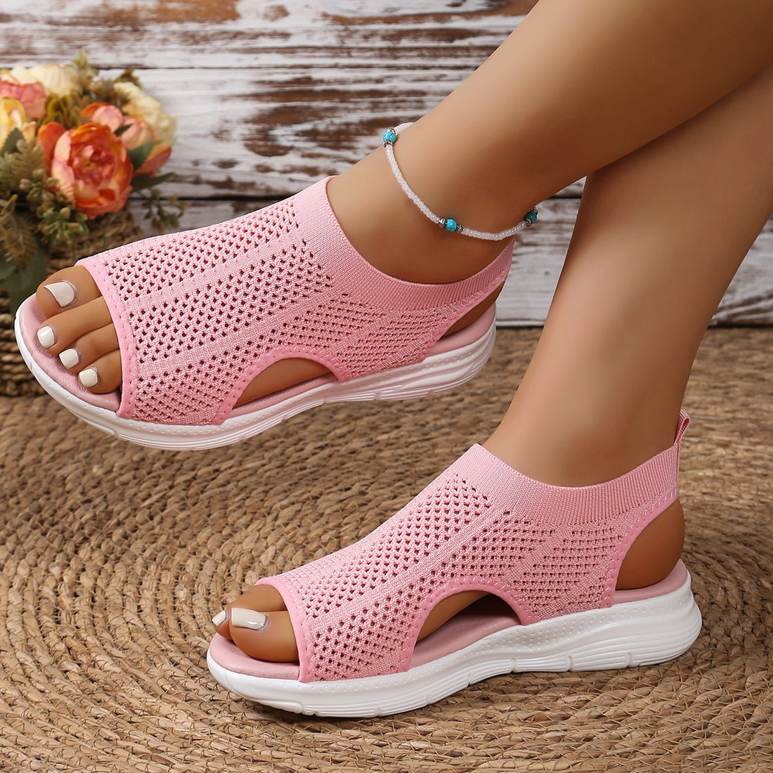Pink mesh open-toe sandals with a chunky white sole and breathable knit upper.