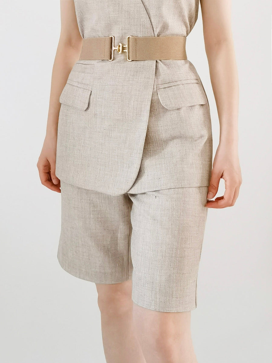 Caramel elastic waist belt with gold sculpted buckle, styled with linen shorts.