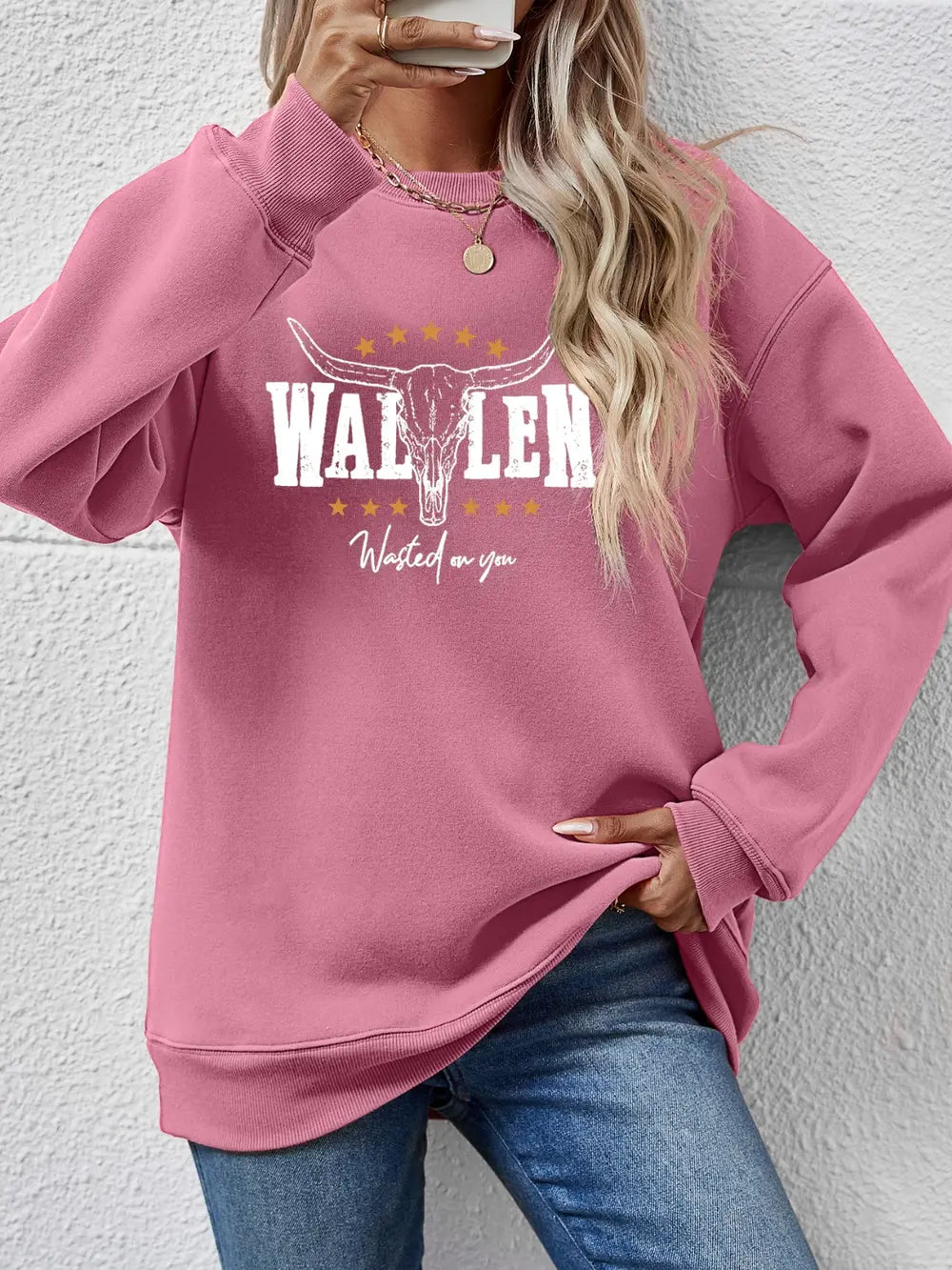 Blush Pink Western Graphic Sweatshirt with bull skull and text graphic.