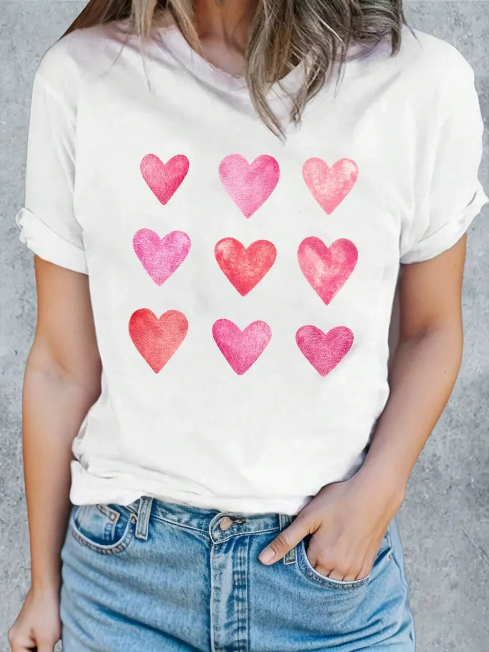 White t-shirt with watercolor heart graphic.