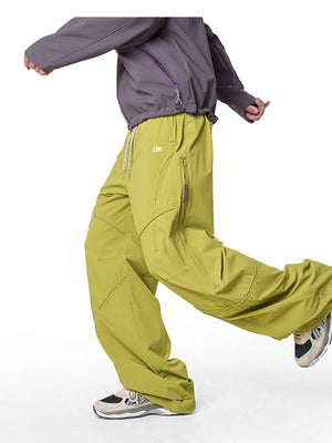 Relaxed fit cargo pants in Mustard Yellow with drawstring and zippered pockets.