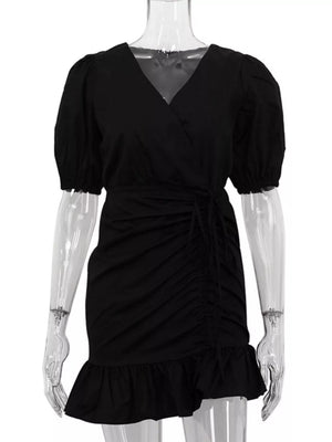 Black wrap dress with puff sleeves, ruched detail, tie waist, and ruffled hem