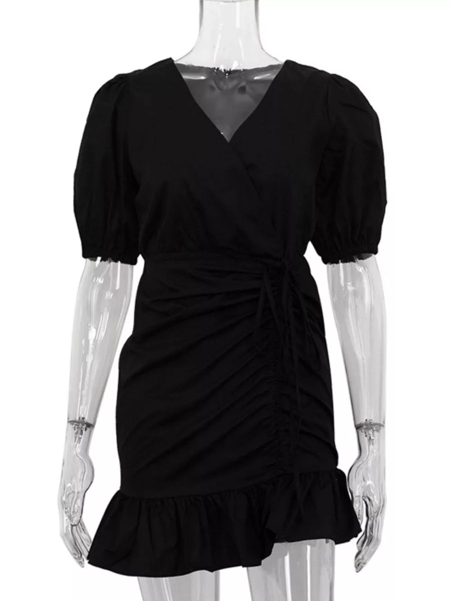 Black wrap dress with puff sleeves, ruched detail, tie waist, and ruffled hem