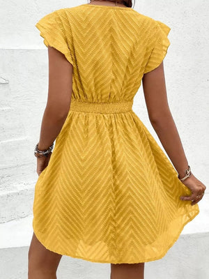 Chevron textured V-neck mini dress in gold with short flutter sleeves and defined waist