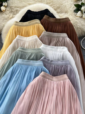 Pleated maxi skirts in brown, yellow, cream, light green, blue, pink, black, apricot, purple, and white.